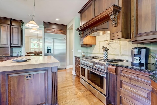 393 Mendon Center Rd, Mendon, NY 14472 - kitchen with premium appliances, butcher block countertops, tasteful backsplash, light wood-style flooring, and hanging light fixtures