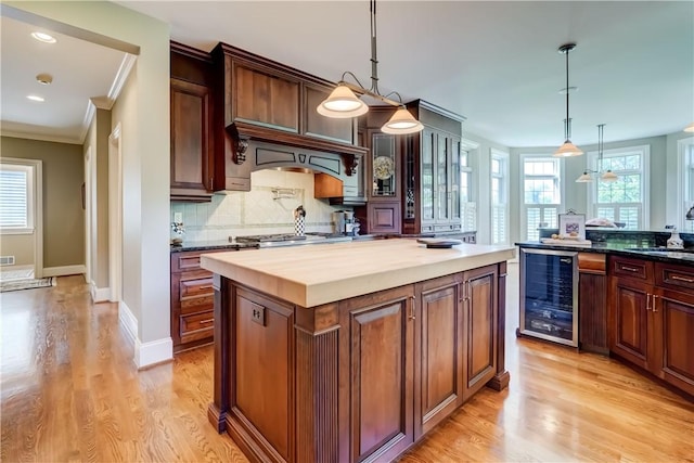 393 Mendon Center Rd, Mendon, NY 14472 - kitchen featuring beverage cooler, plenty of natural light, ornamental molding, light wood-type flooring, and recessed lighting