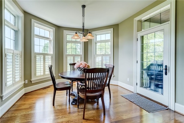 393 Mendon Center Rd, Mendon, NY 14472 - dining area featuring a chandelier and light wood-style floors