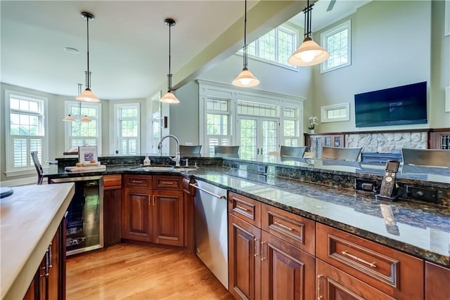 393 Mendon Center Rd, Mendon, NY 14472 - kitchen featuring wine cooler, stainless steel dishwasher, light wood-type flooring, decorative light fixtures, and brown cabinetry