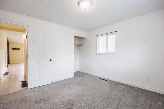 88 Rouge Rd, Henrietta, NY 14623 - unfurnished bedroom with crown molding, a closet, and carpet