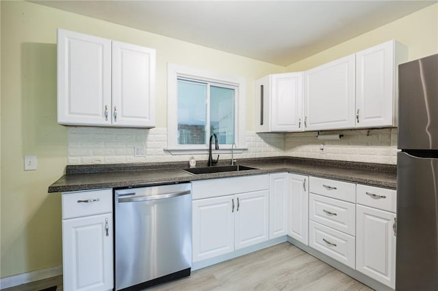 88 Rouge Rd, Henrietta, NY 14623 - kitchen featuring stainless steel appliances, dark countertops, backsplash, and white cabinetry