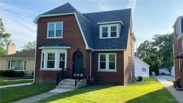 6 Mckinley Pkwy, Buffalo, NY 14220 - english style home with roof with shingles, brick siding, and a front yard