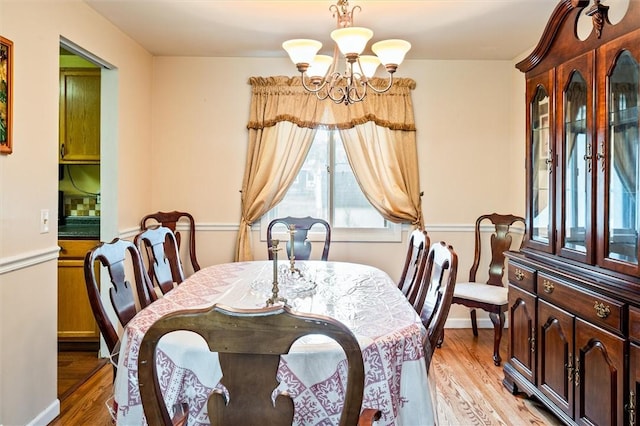 217 Red Lion Rd, Henrietta, NY 14467 - dining room with a chandelier, healthy amount of natural light, and light wood-type flooring