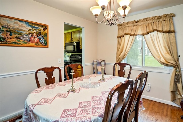 217 Red Lion Rd, Henrietta, NY 14467 - dining area with a chandelier and wood finished floors