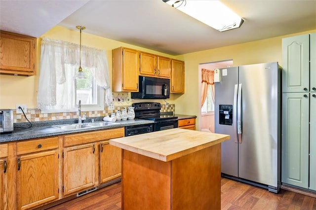 217 Red Lion Rd, Henrietta, NY 14467 - kitchen featuring black appliances, butcher block countertops, dark wood-style floors, pendant lighting, and a kitchen island