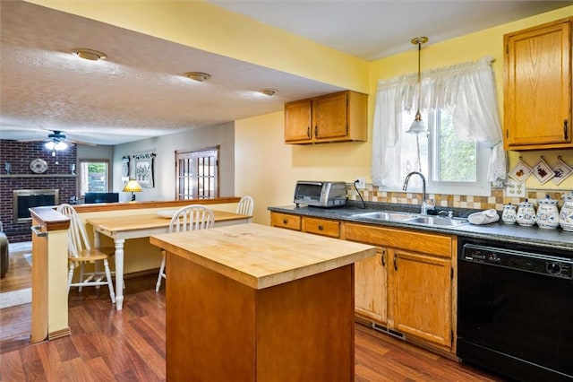 217 Red Lion Rd, Henrietta, NY 14467 - kitchen featuring dishwasher, wood counters, a kitchen island, dark wood finished floors, and a fireplace