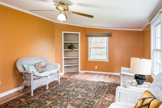 217 Red Lion Rd, Henrietta, NY 14467 - sitting room with wood finished floors, built in features, a ceiling fan, and crown molding