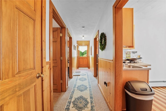 474 Thorpe Rd, Sidney, NY 13838 - corridor featuring wainscoting, a baseboard radiator, wooden walls, and light carpet