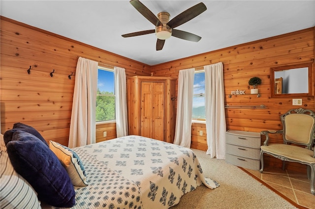 474 Thorpe Rd, Sidney, NY 13838 - bedroom with multiple windows, wood walls, carpet flooring, and ceiling fan