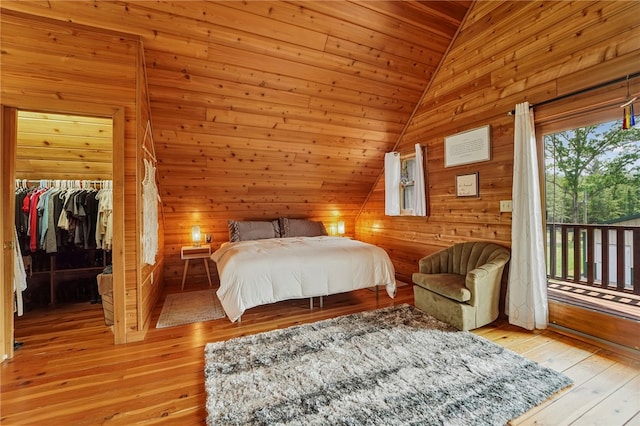 474 Thorpe Rd, Sidney, NY 13838 - bedroom featuring lofted ceiling, wood walls, access to outside, a spacious closet, and light wood-style floors