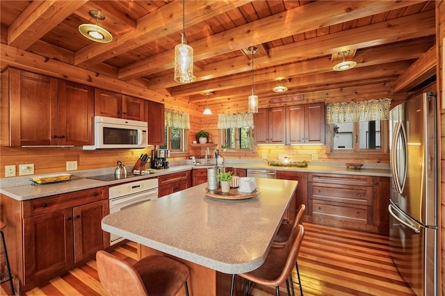 474 Thorpe Rd, Sidney, NY 13838 - kitchen with stainless steel appliances, a wood ceiling with exposed beams, light wood-type flooring, a kitchen bar, and light countertops