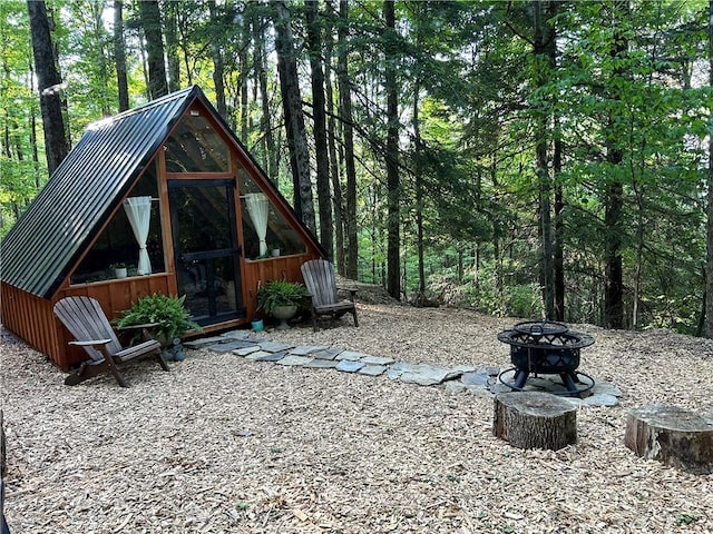 474 Thorpe Rd, Sidney, NY 13838 - exterior space with an outdoor fire pit and a wooded view