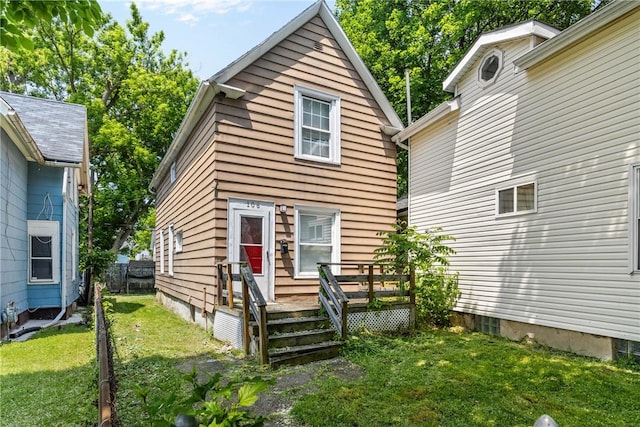 106 Cottage St, Rochester, NY 14608 - rear view of house with a wooden deck and a yard