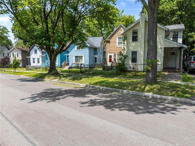 106 Cottage St, Rochester, NY 14608 - view of front of home with a chimney, a residential view, and a front lawn