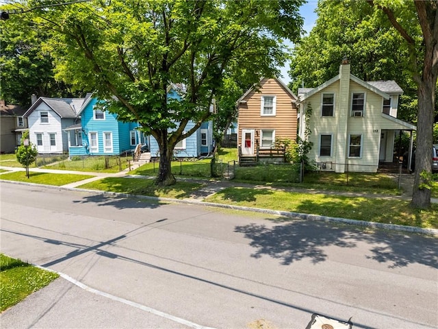 120 Cottage St, Rochester, NY 14608 - view of front of home with a fenced front yard and a chimney