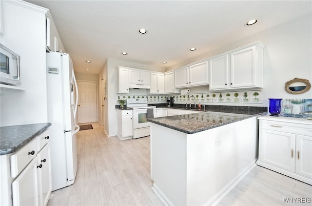 2850 Amsdell Rd Unit 30, Hamburg, NY 14075 - kitchen with white appliances, a peninsula, white cabinetry, recessed lighting, and dark stone counters