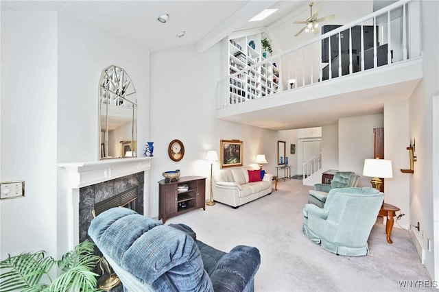2850 Amsdell Rd Unit 30, Hamburg, NY 14075 - carpeted living room featuring a premium fireplace, a towering ceiling, a ceiling fan, and stairway