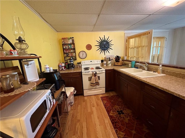 839 State Highway 7, Unadilla, NY 13849 - kitchen with white appliances, light wood-style flooring, a paneled ceiling, and light countertops
