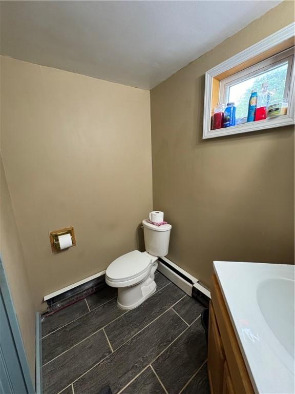 839 State Highway 7, Unadilla, NY 13849 - bathroom with a baseboard radiator, vanity, and wood finish floors