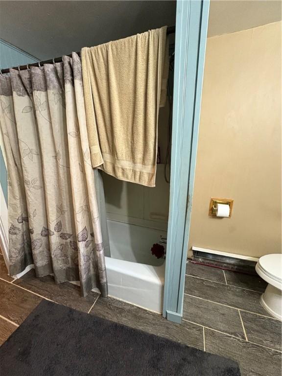 839 State Highway 7, Unadilla, NY 13849 - full bathroom featuring shower / bath combo with shower curtain and wood finished floors