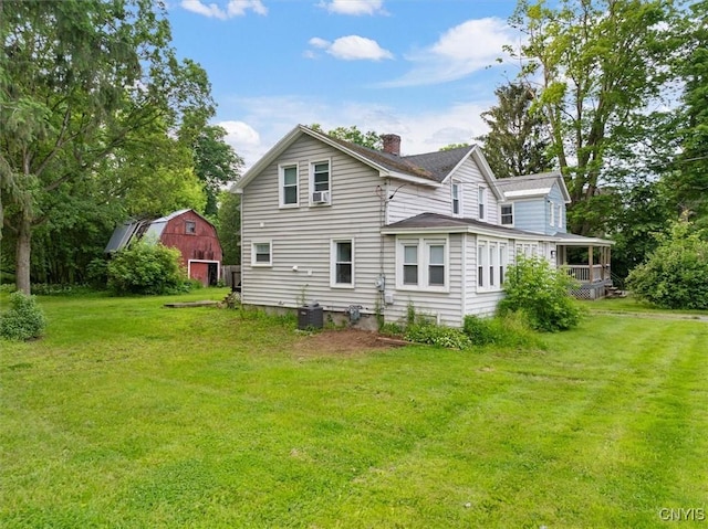 16 Meadow St, Kirkland, NY 13323 - back of property with a barn, a chimney, a lawn, and an outdoor structure