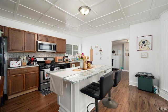 16 Meadow St, Kirkland, NY 13323 - kitchen with stainless steel appliances, a kitchen breakfast bar, dark wood-type flooring, and backsplash