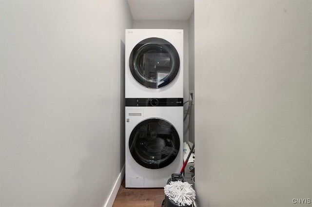 16 Meadow St, Kirkland, NY 13323 - washroom featuring estacked washer and dryer and wood finished floors