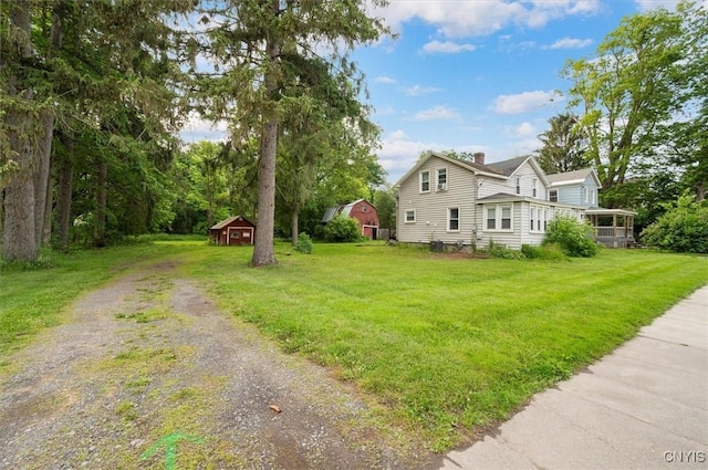 16 Meadow St, Kirkland, NY 13323 - view of home's exterior featuring a chimney, a lawn, driveway, and an outdoor structure