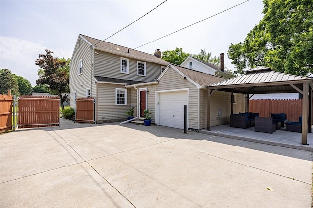 262 Barry Rd, Irondequoit, NY 14617 - view of front of house with outdoor lounge area, an attached garage, a gazebo, and a gate