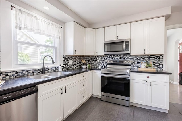 262 Barry Rd, Irondequoit, NY 14617 - kitchen with stainless steel appliances, dark countertops, white cabinets, and recessed lighting