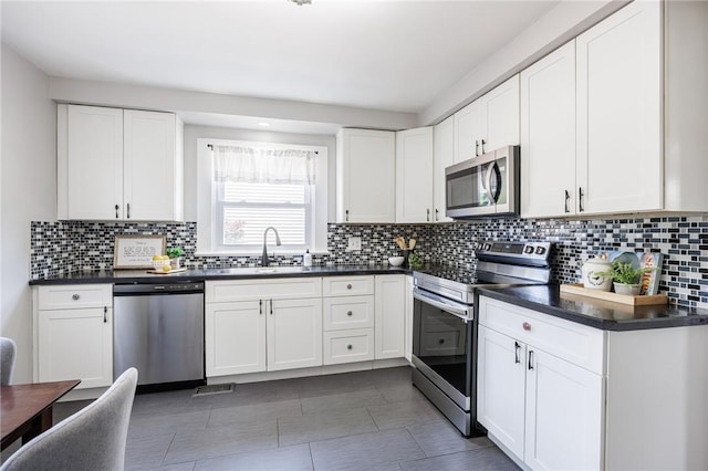262 Barry Rd, Irondequoit, NY 14617 - kitchen with appliances with stainless steel finishes, dark countertops, and decorative backsplash
