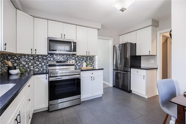 262 Barry Rd, Irondequoit, NY 14617 - kitchen featuring stainless steel appliances, dark countertops, and backsplash