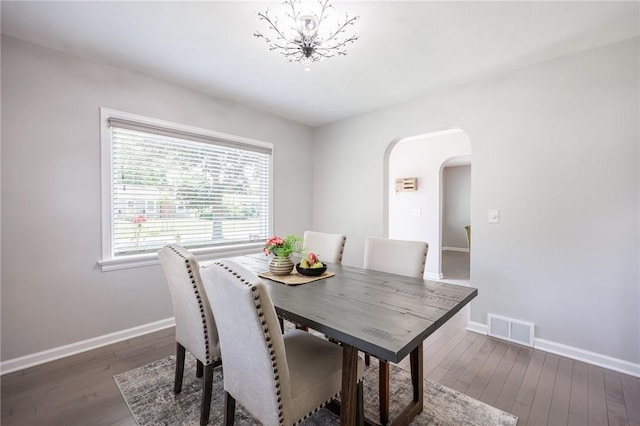 262 Barry Rd, Irondequoit, NY 14617 - dining area with arched walkways, wood-type flooring, and a chandelier