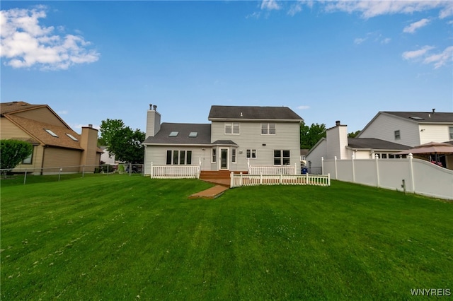 33 Sausalito Dr, Amherst, NY 14051 - rear view of house with a fenced backyard, a deck, and a chimney