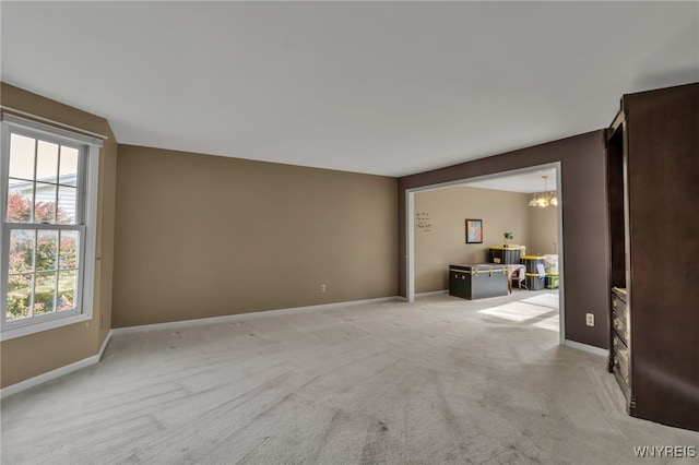 33 Sausalito Dr, Amherst, NY 14051 - unfurnished living room featuring light colored carpet, a chandelier, and an office area