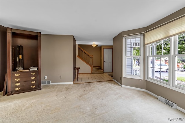 33 Sausalito Dr, Amherst, NY 14051 - unfurnished living room featuring stairway and carpet