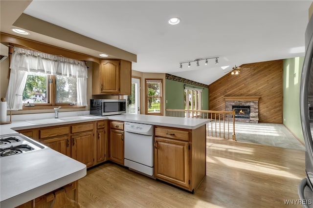 33 Sausalito Dr, Amherst, NY 14051 - kitchen featuring stainless steel appliances, wood walls, ceiling fan, light countertops, and lofted ceiling