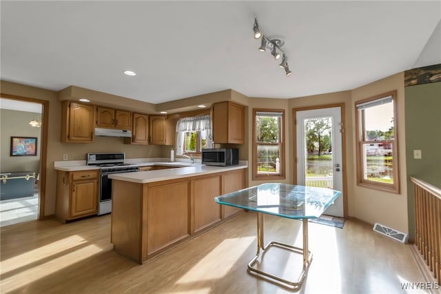 33 Sausalito Dr, Amherst, NY 14051 - kitchen featuring gas range oven, light wood-type flooring, stainless steel microwave, under cabinet range hood, and light countertops