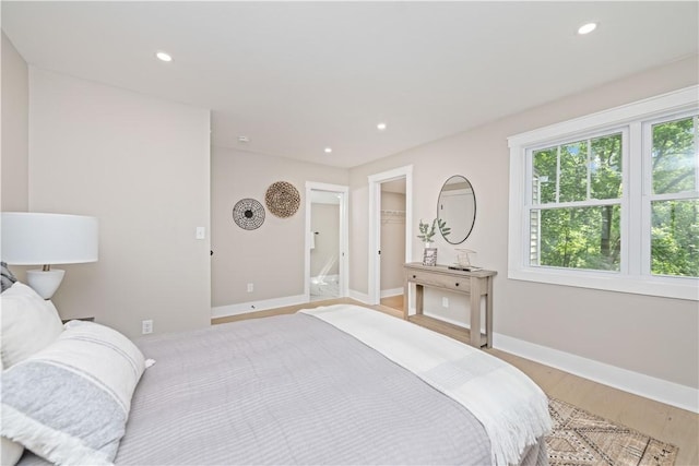 38 Richs Dugway Rd, Brighton, NY 14625 - bedroom with recessed lighting, a walk in closet, and light wood-style floors