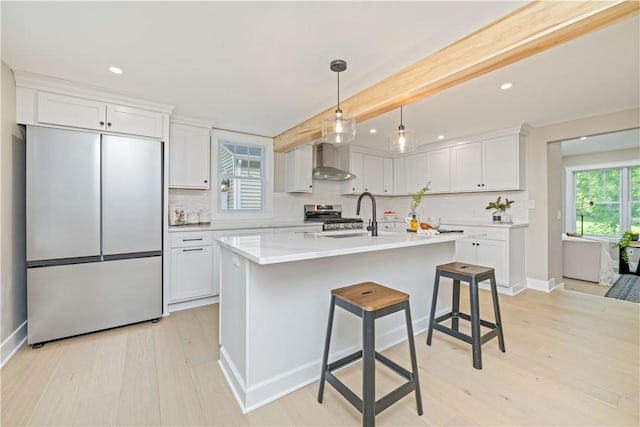 38 Richs Dugway Rd, Brighton, NY 14625 - kitchen with built in refrigerator, wall chimney exhaust hood, light wood-style floors, stainless steel range oven, and white cabinets