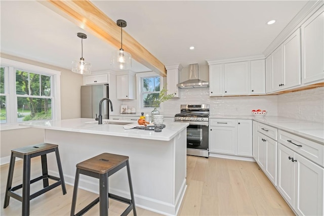 38 Richs Dugway Rd, Brighton, NY 14625 - kitchen featuring wall chimney range hood, appliances with stainless steel finishes, light wood finished floors, plenty of natural light, and recessed lighting