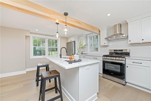 38 Richs Dugway Rd, Brighton, NY 14625 - kitchen featuring appliances with stainless steel finishes, wall chimney exhaust hood, light wood-style flooring, tasteful backsplash, and white cabinetry