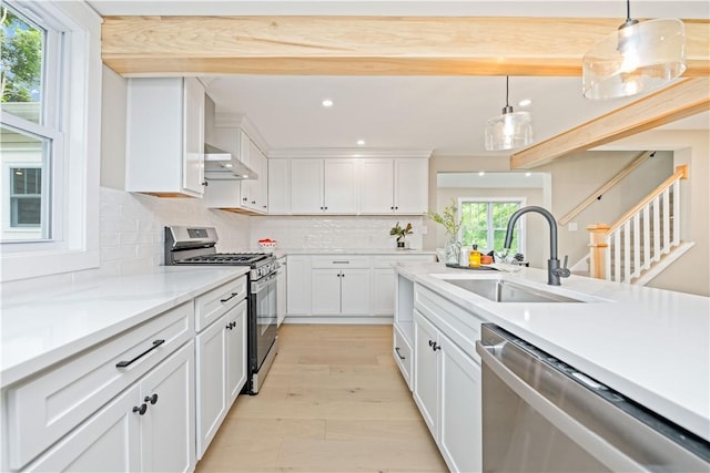 38 Richs Dugway Rd, Brighton, NY 14625 - kitchen with stainless steel appliances, exhaust hood, white cabinetry, light countertops, and decorative backsplash