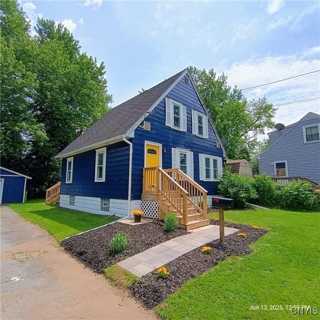 504 Breman Ave, Salina, NY 13211 - view of front of property with roof with shingles, a front lawn, and an outbuilding