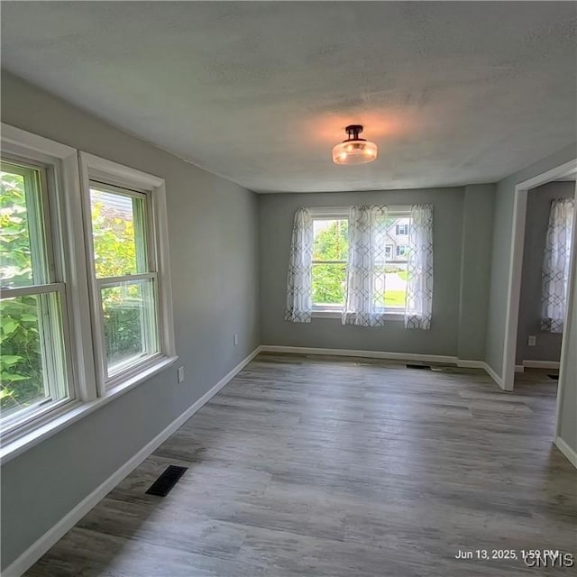 504 Breman Ave, Salina, NY 13211 - unfurnished dining area featuring wood finished floors and a textured ceiling