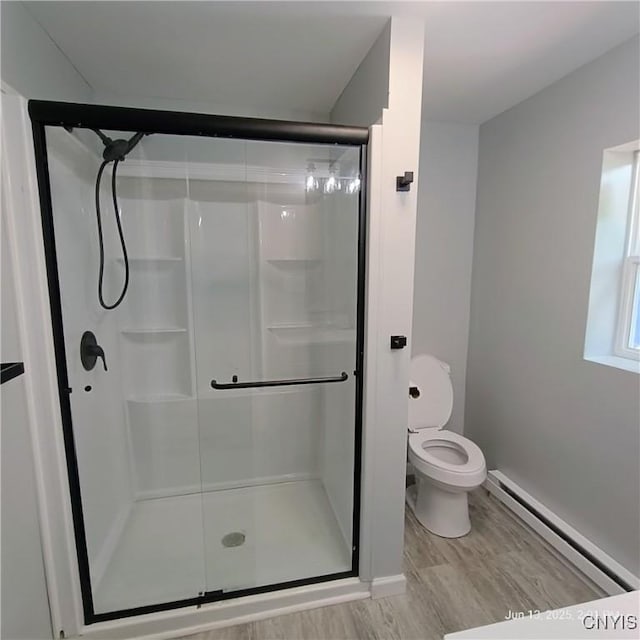 504 Breman Ave, Salina, NY 13211 - bathroom featuring a baseboard radiator, a shower stall, and wood finished floors