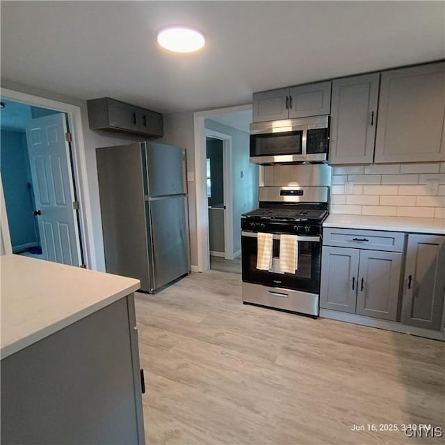 504 Breman Ave, Salina, NY 13211 - kitchen featuring appliances with stainless steel finishes, gray cabinets, light countertops, and light wood finished floors