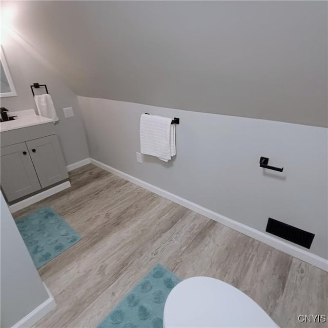 504 Breman Ave, Salina, NY 13211 - bathroom featuring vanity, wood finished floors, and lofted ceiling