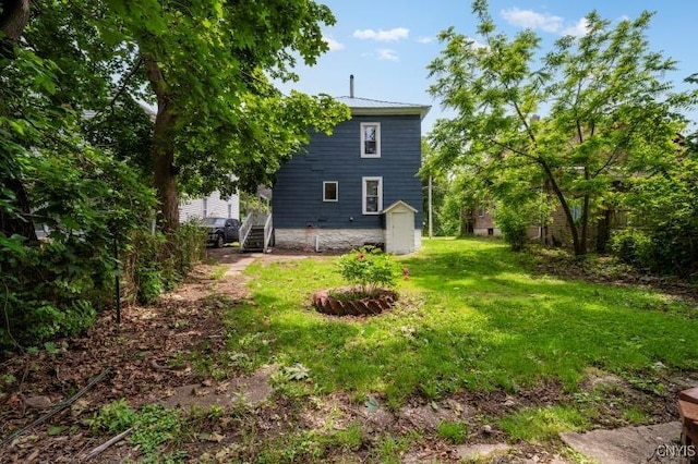 321 Pleasant Ave, Oneida-Inside, NY 13421 - back of house with a storage shed and a yard